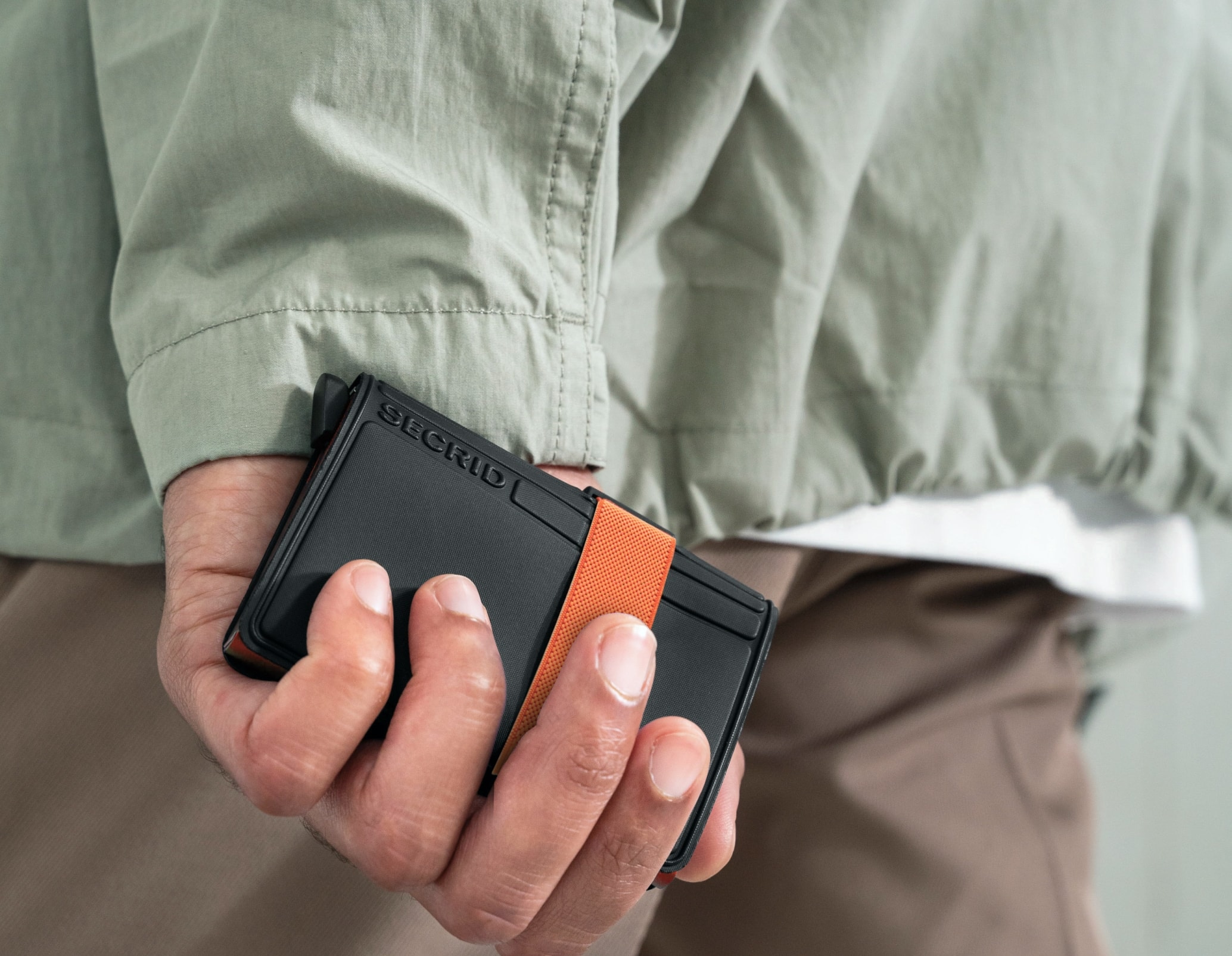 Real life image of the add-on-bandwallet-orange wallet